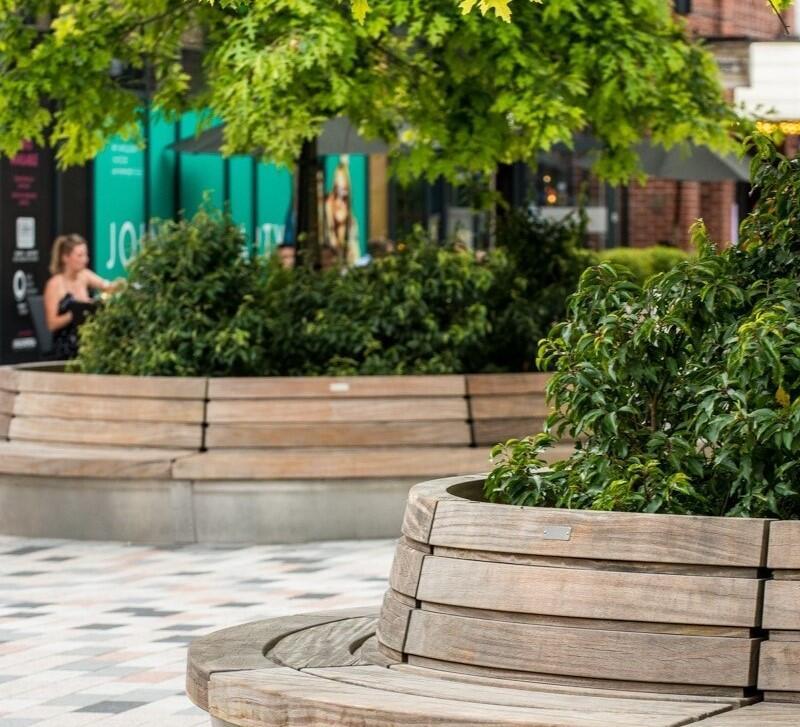 A photograph of large tree planters with integrated seating. © BMD