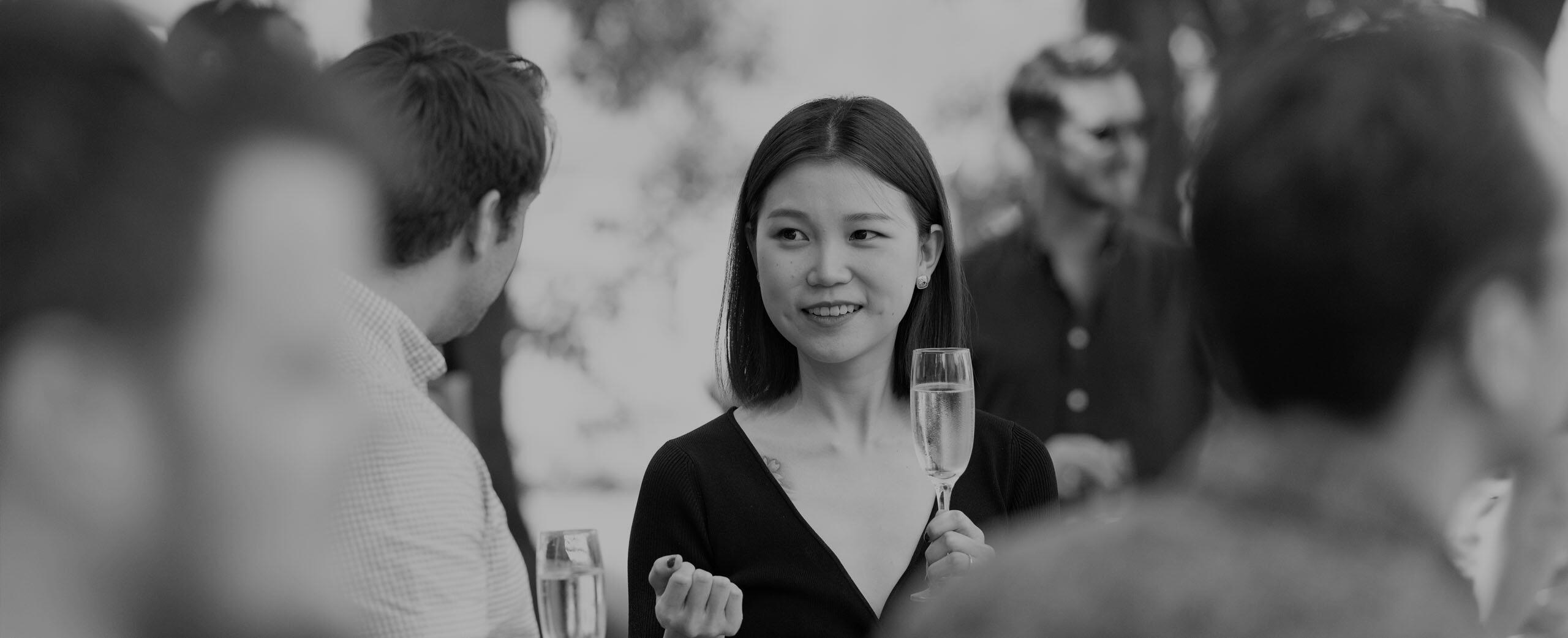  A black and white photograph of a BMD employee at a social event
