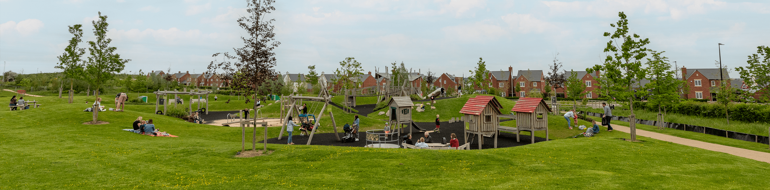 A photograph of families enjoying the play area at Houlton. © BMD
