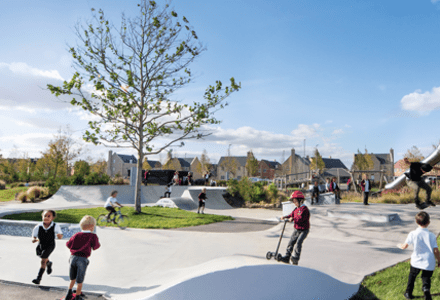 A photograph of children playing in skate park