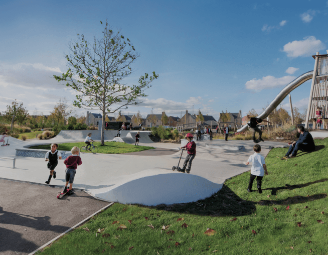 A photograph of children playing in skate park